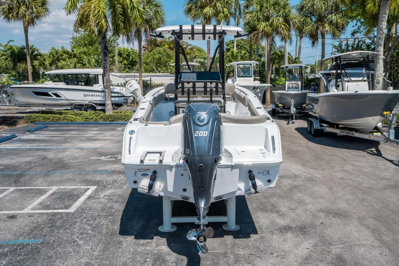 Slide: The Image of 2025 Sea Hunt Ultra 229 boat with Yamaha 200 engine, parked outdoors. - 3