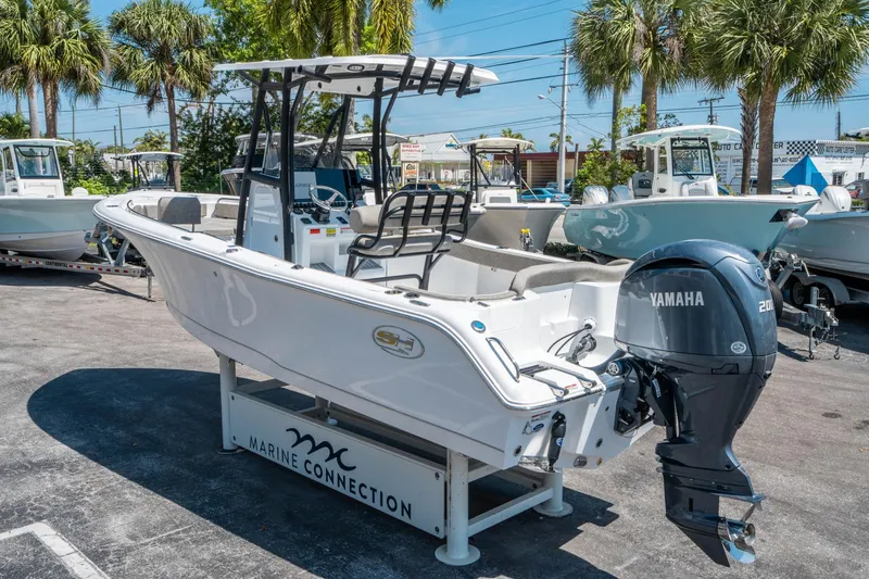 Slide: The Image of 2025 Sea Hunt Ultra 229 boat with Yamaha engine displayed outdoors. - 4