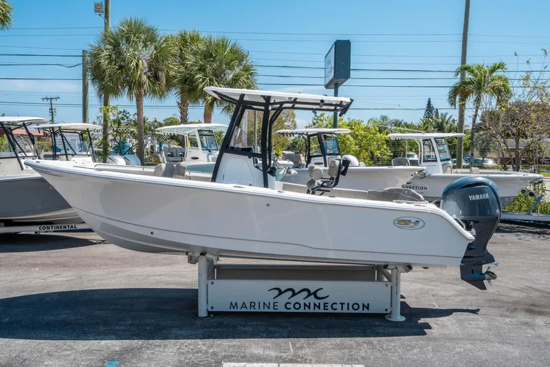 Slide: The Image of 2025 Sea Hunt Ultra 229 boat displayed at Marine Connection dealership. - 5