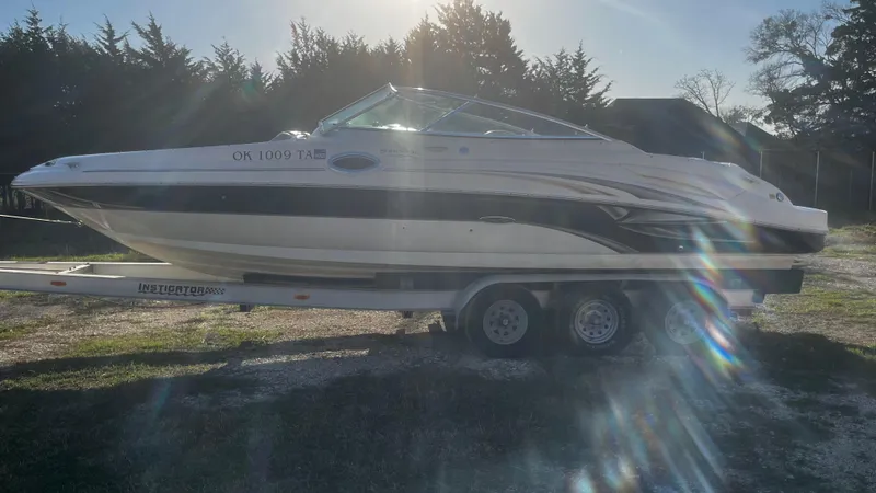 The Image of 2002 Sea Ray 270 Sundeck boat on trailer, parked outdoors. - 1