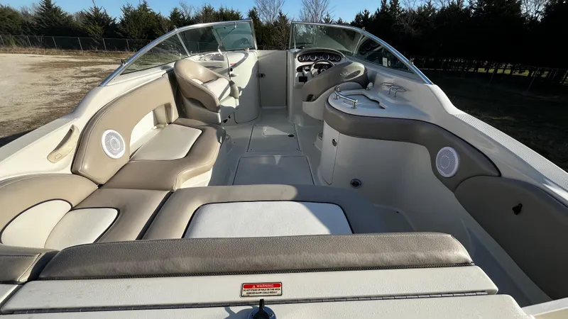 Slide: The Image of 2002 Sea Ray 270 Sundeck boat interior with dual seating and cup holders. - 3