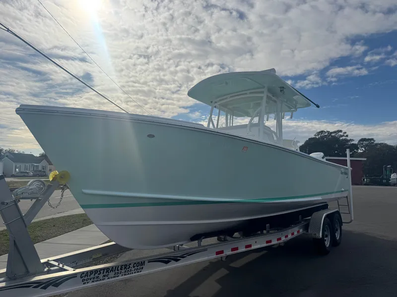 Slide: The Image of 2023 Albury Brothers 27 boat on trailer under cloudy sky. - 0