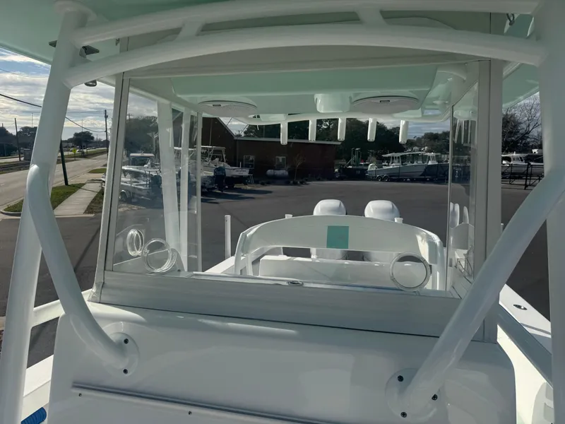 Slide: The Image of 2023 Albury Brothers 27 boat, interior view, showcasing helm and seating area. - 11