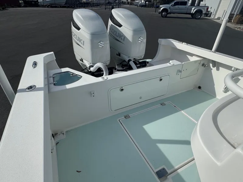 Slide: The Image of 2023 Albury Brothers 27 boat with dual Suzuki outboard engines, docked on a sunny day. - 12