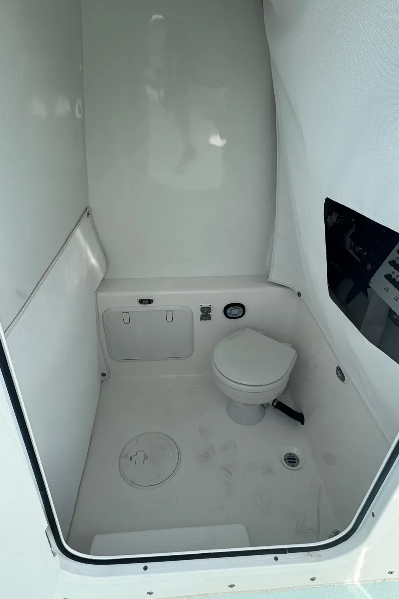 Slide: The Image of 2023 Albury Brothers 27 boat interior with compact marine toilet. - 17