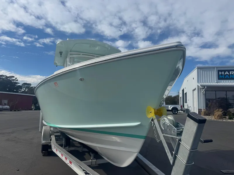Slide: The Image of 2023 Albury Brothers 27 boat on trailer under a partly cloudy sky. - 2