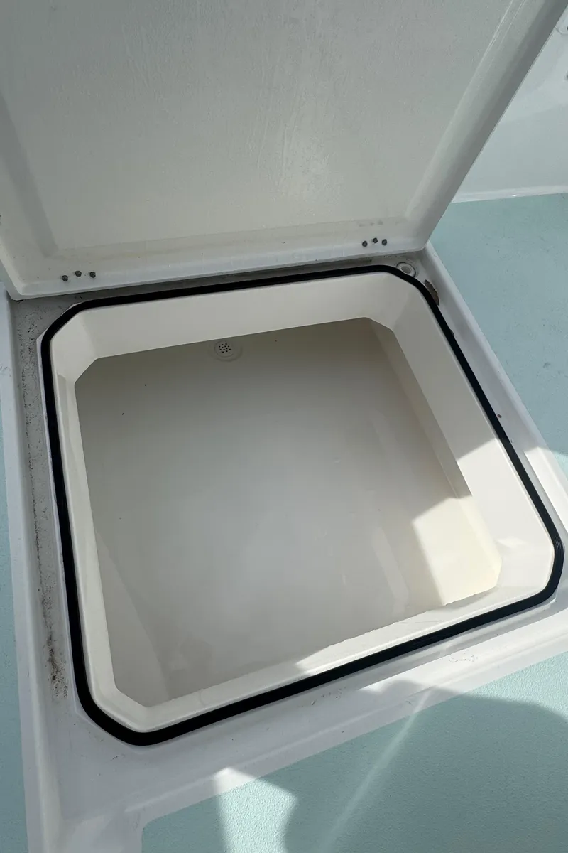 Slide: The Image of Open storage compartment on 2023 Albury Brothers 27 boat, featuring a clean, white interior. - 21