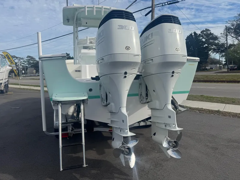 Slide: The Image of 2023 Albury Brothers 27 boat with dual Suzuki 300 outboard engines, parked on a street. - 3