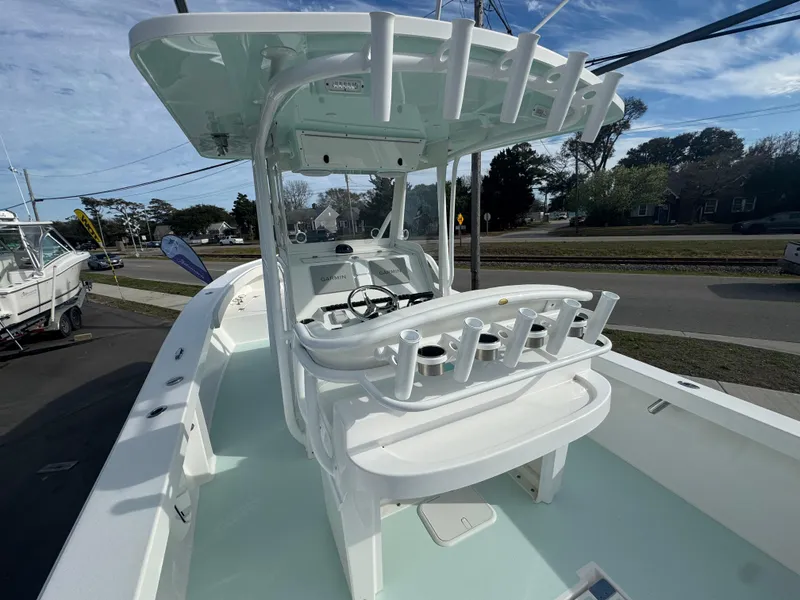 Slide: The Image of 2023 Albury Brothers 27 boat with center console and rod holders, docked outdoors. - 5