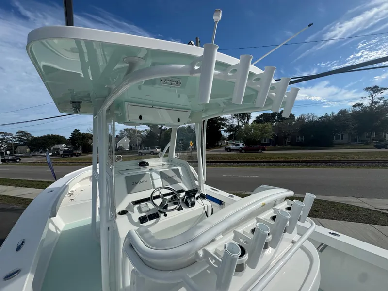 Slide: The Image of 2023 Albury Brothers 27 boat with center console and rod holders, parked on a street. - 6
