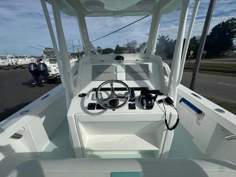 Slide: The Image of 2023 Albury Brothers 27 boat cockpit with Garmin navigation system and steering wheel. - 7