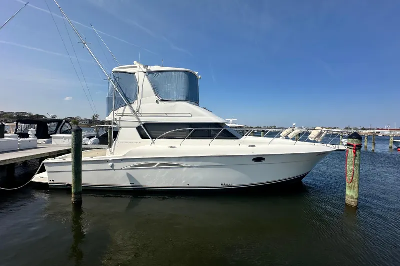 Slide: The Image of 2006 Silverton 42 Convertible yacht docked at marina under clear blue sky. - 11