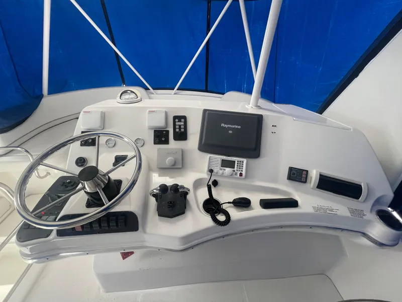 Slide: The Image of Helm of 2006 Silverton 42 Convertible yacht with steering wheel and navigation equipment. - 16
