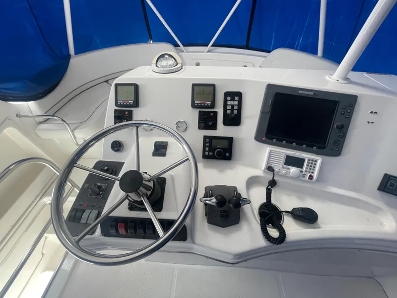 Slide: The Image of 2006 Silverton 42 Convertible yacht helm with steering wheel and navigation instruments. - 17