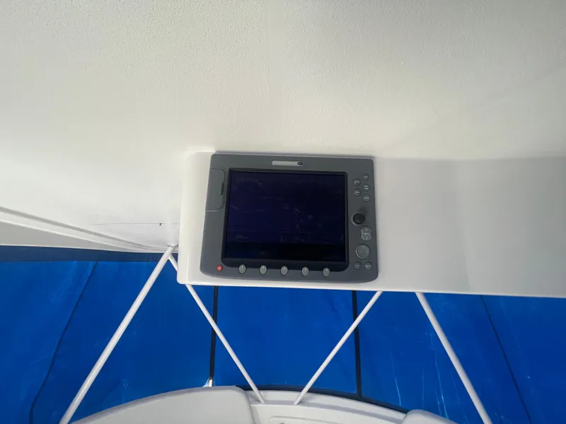 Slide: The Image of Control panel on 2006 Silverton 42 Convertible yacht, featuring a blue canopy. - 19