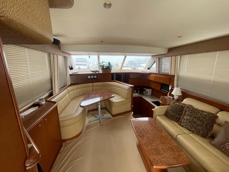 Slide: The Image of Luxurious interior of a 2006 Silverton 42 Convertible yacht with elegant seating and wood finishes. - 24