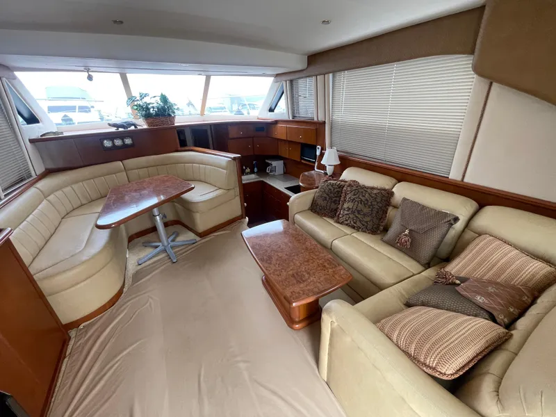 Slide: The Image of Luxurious interior of a 2006 Silverton 42 Convertible yacht with plush seating and elegant decor. - 25