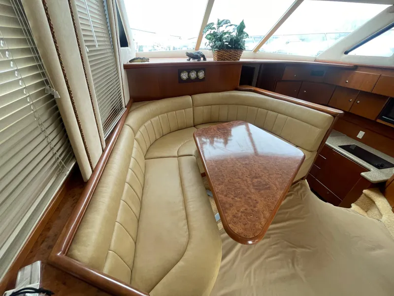 Slide: The Image of Luxurious interior of 2006 Silverton 42 Convertible yacht with plush seating and elegant wood table. - 29
