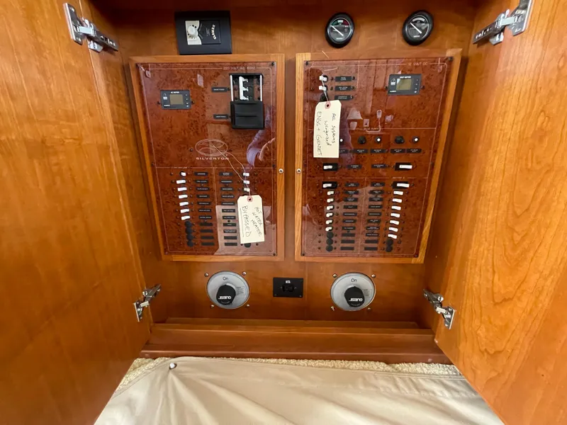Slide: The Image of Electrical panel inside a 2006 Silverton 42 Convertible yacht, featuring switches and gauges. - 32