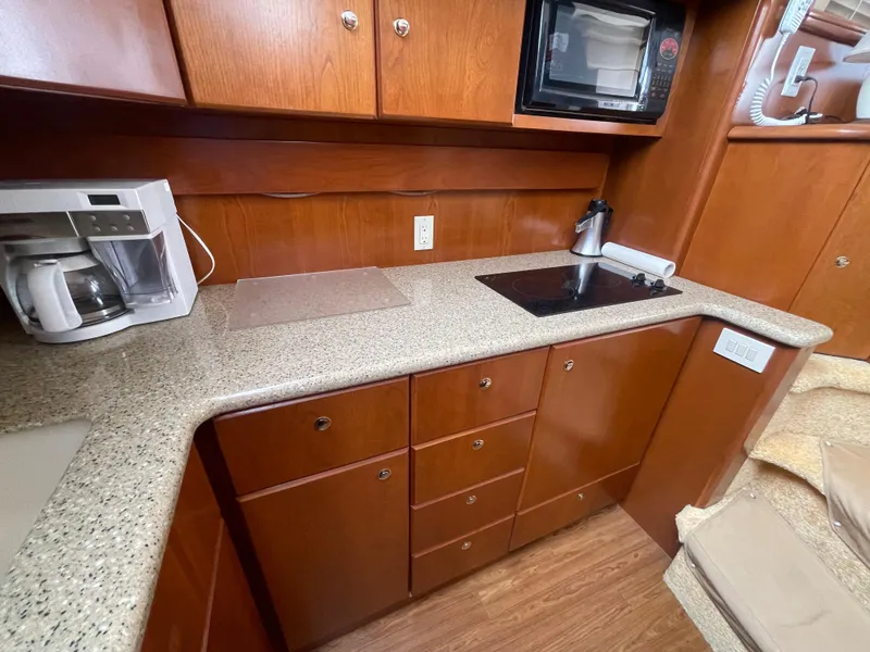 Slide: The Image of 2006 Silverton 42 Convertible yacht kitchen with microwave, coffee maker, and sleek cabinetry. - 36