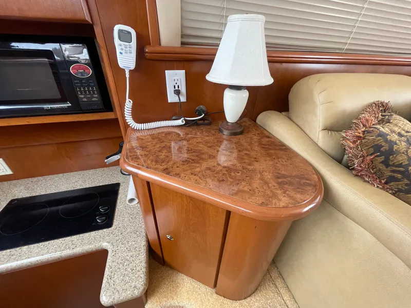 Slide: The Image of Interior of 2006 Silverton 42 Convertible yacht with lamp, microwave, and sofa. - 37