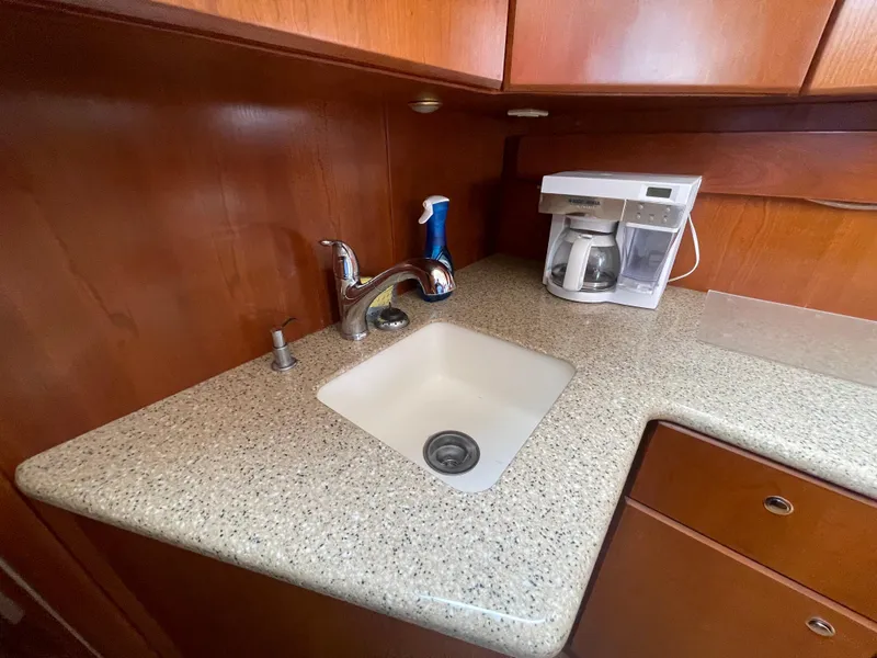 Slide: The Image of 2006 Silverton 42 Convertible yacht kitchen with sink and coffee maker. - 38