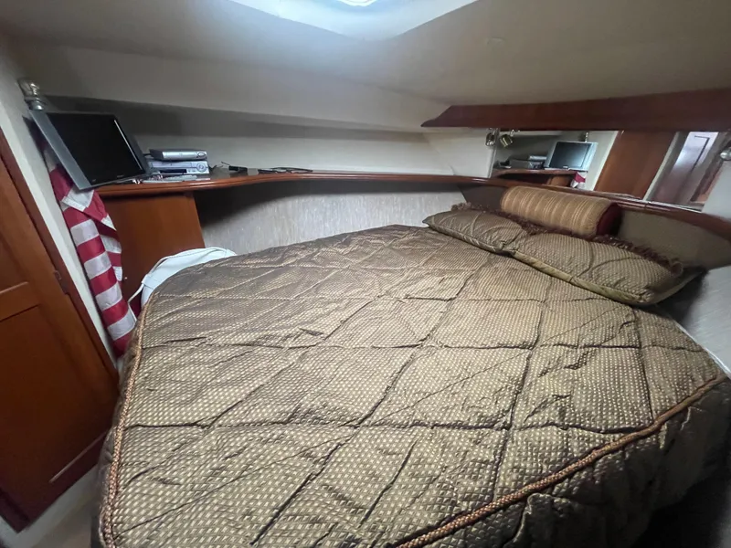 Slide: The Image of Cozy bedroom in 2006 Silverton 42 Convertible yacht with quilted bedding. - 40