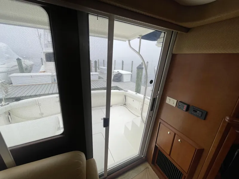 Slide: The Image of Interior view of a 2006 Silverton 42 Convertible yacht, showing sliding door to deck. - 42