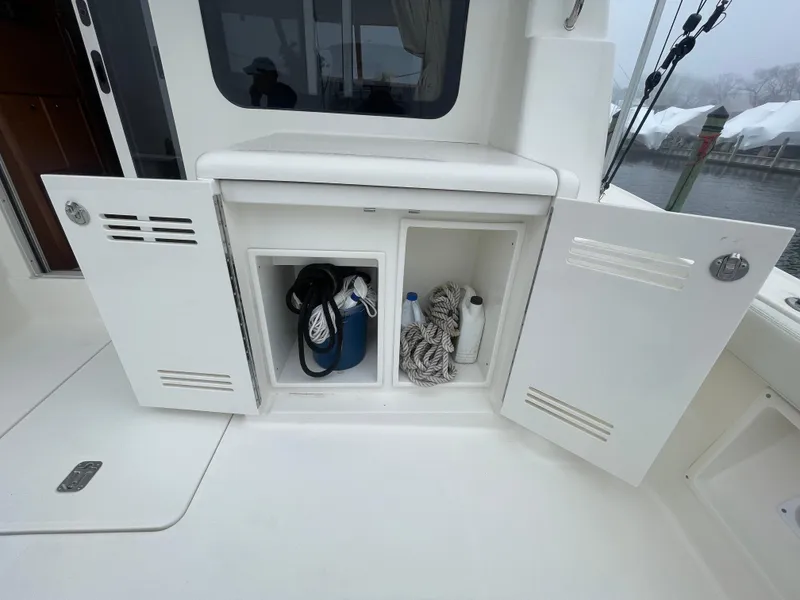 Slide: The Image of Open storage compartment on a 2006 Silverton 42 Convertible boat deck. - 44
