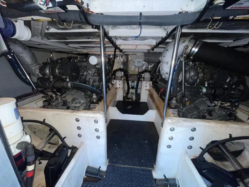 Slide: The Image of Engine room of a 2006 Silverton 42 Convertible yacht, showcasing dual engines and mechanical components. - 47