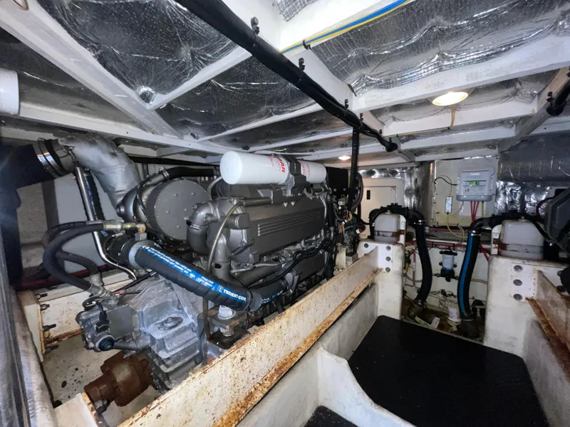 Slide: The Image of Engine room of a 2006 Silverton 42 Convertible yacht, showcasing mechanical components and systems. - 48
