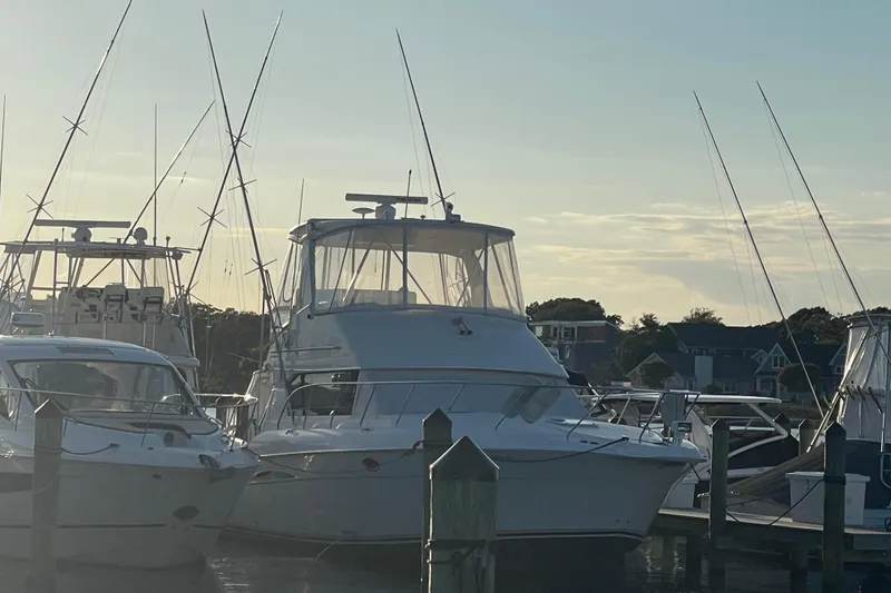 Slide: The Image of 2006 Silverton 42 Convertible yacht docked at marina during sunset. - 7