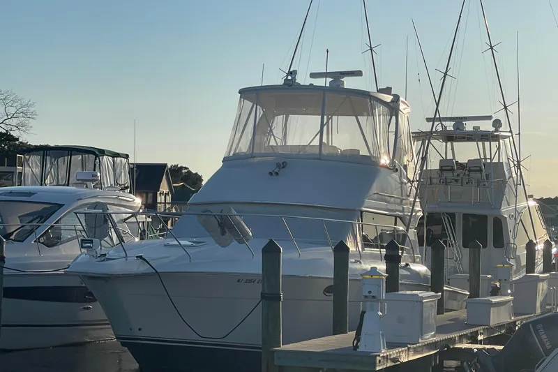 Slide: The Image of 2006 Silverton 42 Convertible yacht docked at marina during sunset. - 9