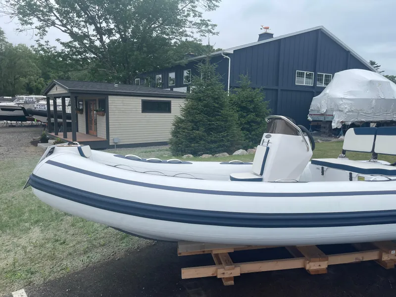 Slide: The Image of 2025 AB Inflatables Alumina 15 ALX boat displayed outdoors on wooden stand. - 16