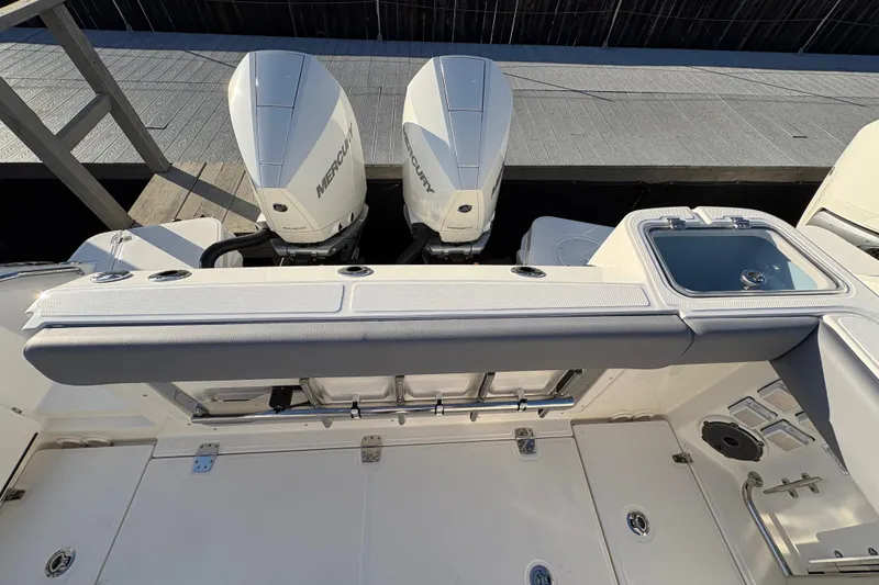 Slide: The Image of 2026 Boston Whaler 325 Conquest boat with dual Mercury engines and deck view. - 16