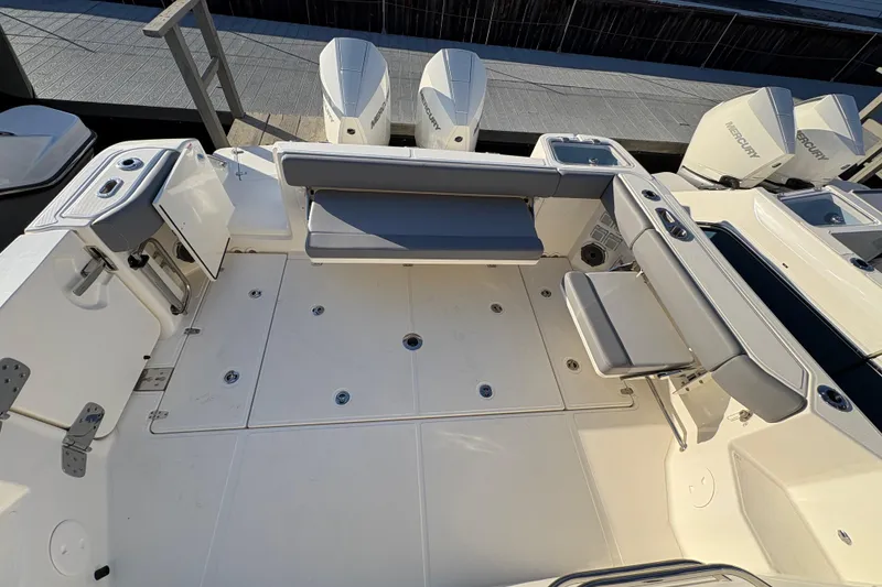 Slide: The Image of 2026 Boston Whaler 325 Conquest boat deck with seating and storage compartments. - 17