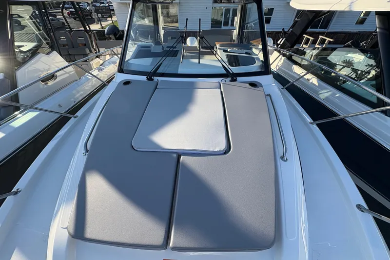 Slide: The Image of 2026 Boston Whaler 325 Conquest boat deck with cushioned seating and sleek design. - 20