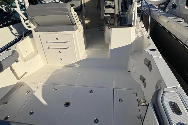 Slide: The Image of 2026 Boston Whaler 325 Conquest boat interior with seating and storage compartments. - 3
