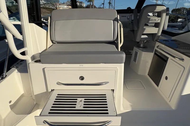 Slide: The Image of 2026 Boston Whaler 325 Conquest interior with seating and storage compartments. - 5