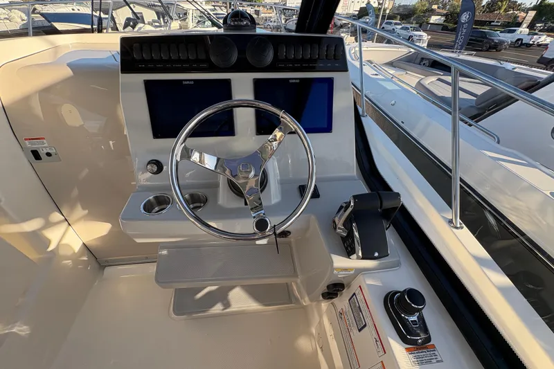 Slide: The Image of Helm of 2026 Boston Whaler 325 Conquest with dual screens and modern controls. - 8