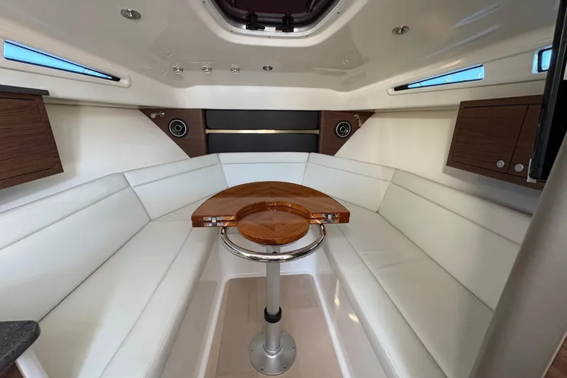 Slide: The Image of Luxurious interior of 2026 Boston Whaler 325 Conquest with elegant seating and wooden table. - 9