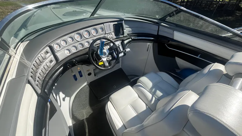 Slide: The Image of 2005 Cobalt 343 boat interior with sleek dashboard and white leather seating. - 10