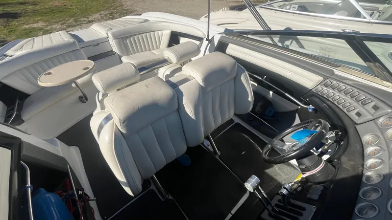 Slide: The Image of Interior of a 2005 Cobalt 343 boat with white leather seats and steering wheel. - 11