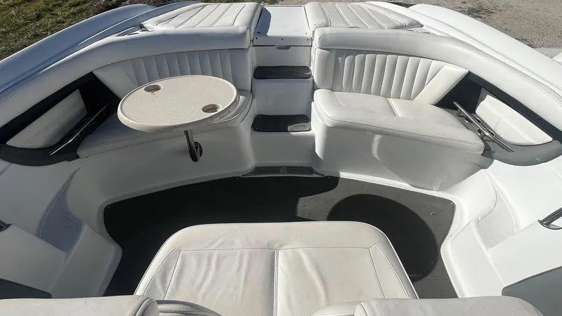 Slide: The Image of 2005 Cobalt 343 boat interior with white seating and a small round table. - 12