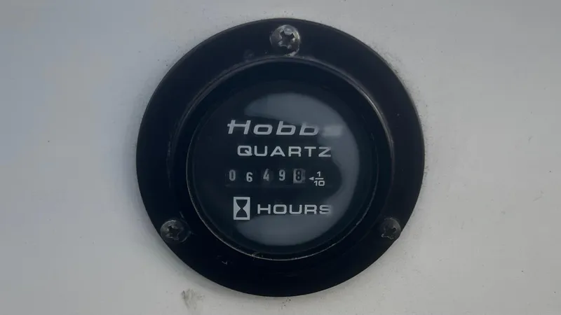 Slide: The Image of Hour meter reading 6498.1 hours on a 2005 Cobalt 343 boat. - 14