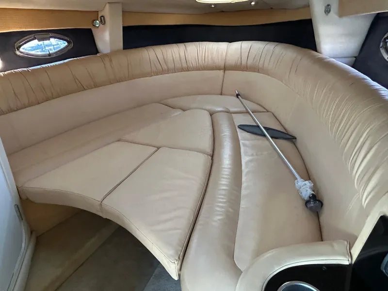 Slide: The Image of Luxurious interior of a 2005 Cobalt 343 boat with beige leather seating. - 16