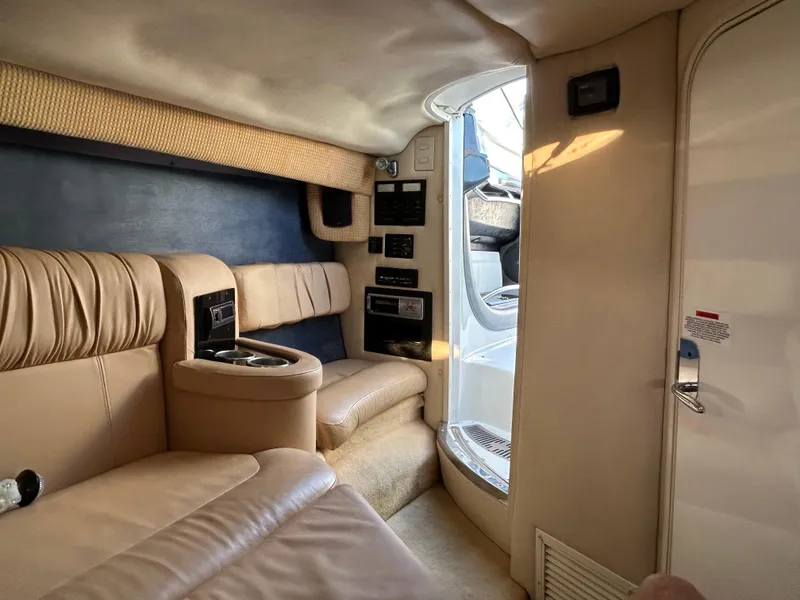Slide: The Image of Luxurious interior of a 2005 Cobalt 343 boat with beige leather seating. - 18