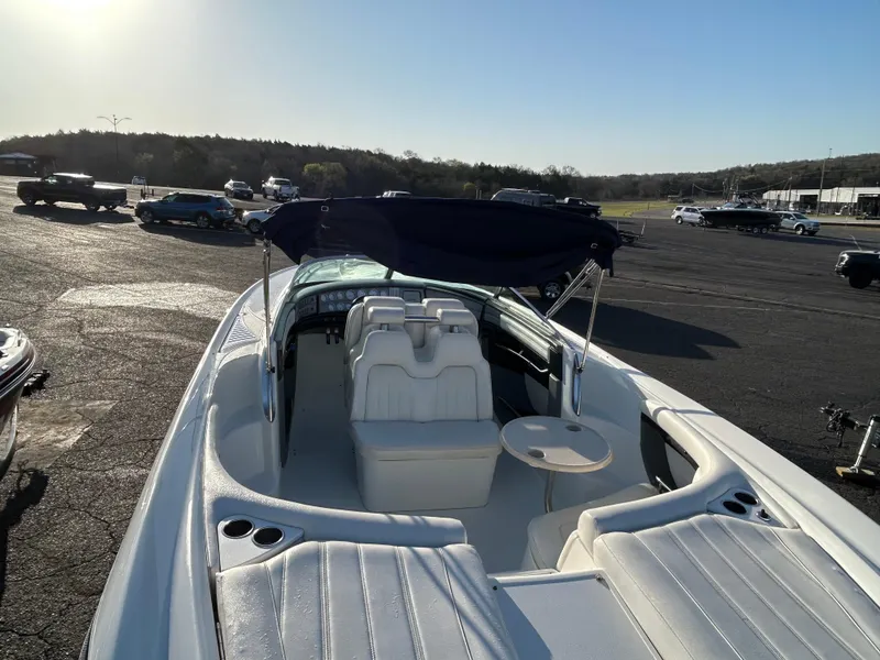 Slide: The Image of 2005 Cobalt 343 boat with seating and canopy, parked in a sunny outdoor area. - 6