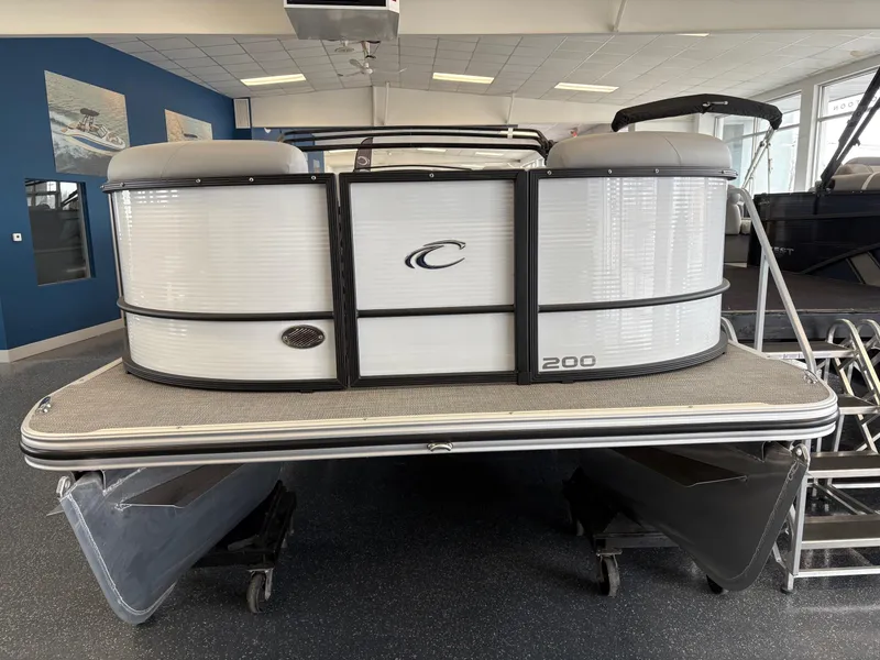 Slide: The Image of 2025 Crest 200 SLC Classic LX pontoon boat in showroom, front view. - 2