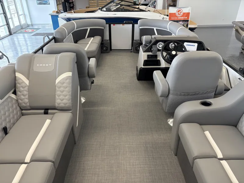 Slide: The Image of 2025 Crest 200 SLC Classic LX pontoon boat interior with gray seating and modern dashboard. - 6